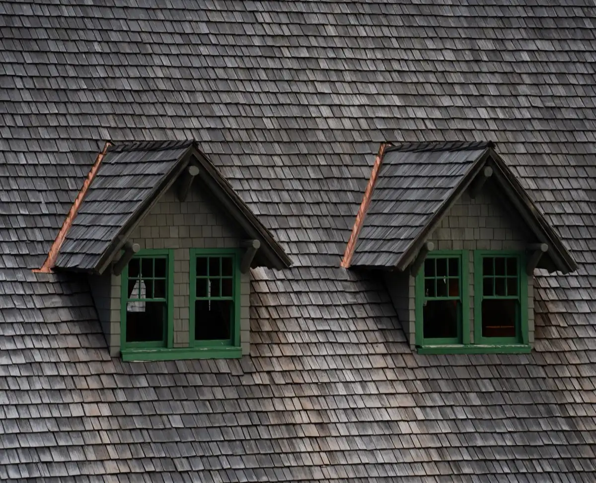 Dormers on a shingle roof in San Angelo, TX, where step flashing and kickout flashing carry water past the walls
